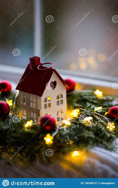 Toy House with Hole in Form of Heart Near Fir Wreath Decorated with Red ...