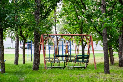 Premium Photo | Swing in the park Playground for childrens games in the ...