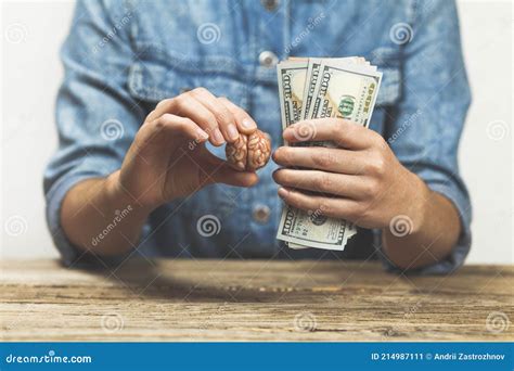 Hands Hold Money and a Brain. Making Money with Your Intellect Stock ...