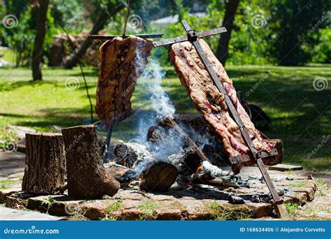 Asado, Traditional Barbecue Dish In Argentina, Roasted Meat Cooked On A ...