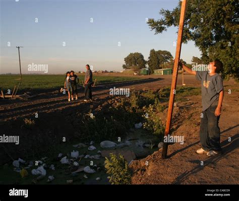Jose Maya (cq), 12 years-old, looks up at the water line on a 10 foot ...