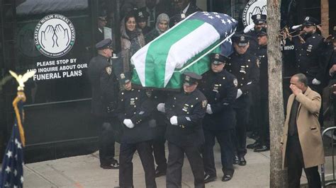 Slain NYPD officer carried in flag-draped coffin from funeral service ...