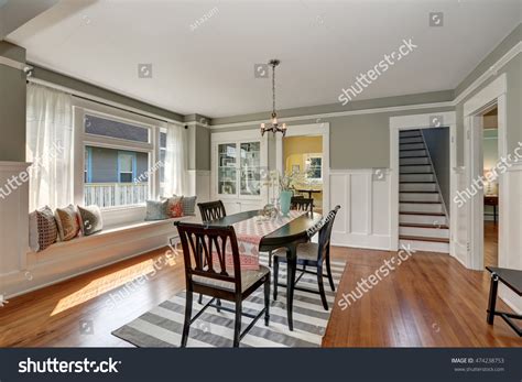 View of a classic dining room with gray walls and medium tone hardwood ...