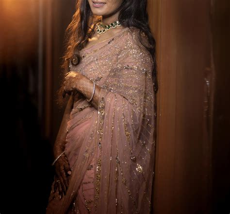 Bride from Dubai in peach pink tulle wedding saree by Archana Karthick