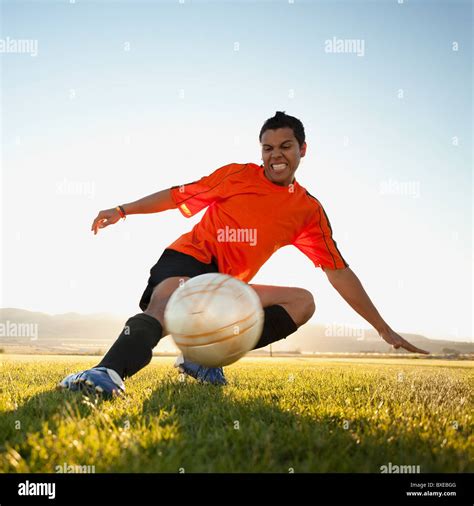 Soccer player kicking the ball Stock Photo - Alamy