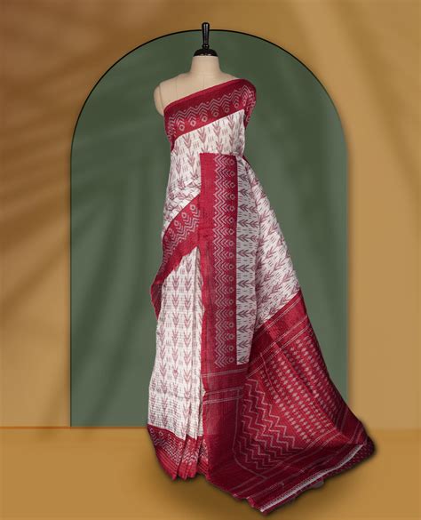 Classic off white colour saree adorned with intricate maroon tribal mo