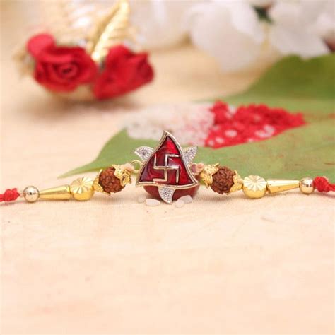 Send AD Stones Studded Swastika Rakhi Online