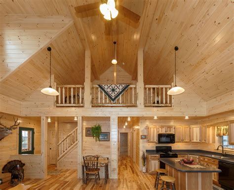 a kitchen and living room in a log cabin style home with wood floors ...
