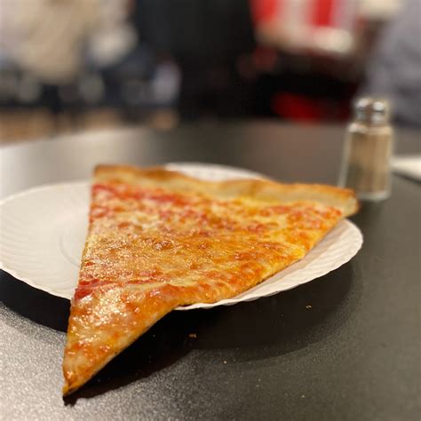 A slice of cheese pizza at Joe’s - Cambridge Day
