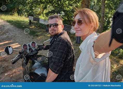 Middle Age Couple Riding a Motorcycle Having Fun and Taking Selfies ...