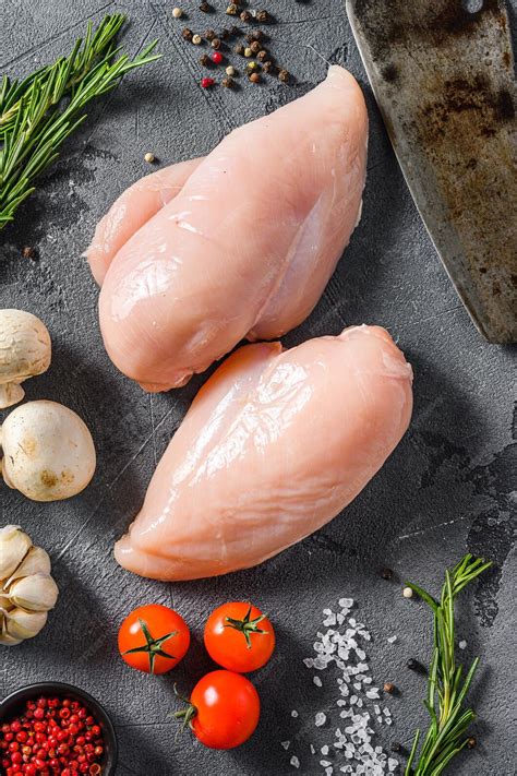 Premium Photo | Raw organic chicken breast with meat butcher cleaver on ...