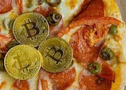 celebrates bitcoin pizza price drops