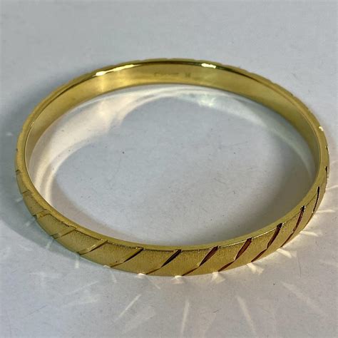 Monet Gold tone bangle bracelet with a touch of... | Depop