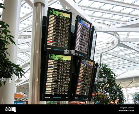 Passengers look at flight delays on a departure board at Orlando International Airport on November 0