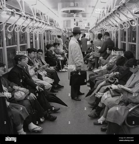 1960s, historical, Japan, Tokyo metro, Japanese commuters travelling in ...