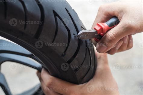 screw nail or Iron stuck puncturing motorcycle or scooter tire,mechanic repair a tire puncture ...