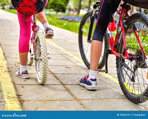 Bikes Bicyclist Girl. Children Feet and Bicycle Wheel. Low Section ...