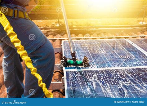 Solar Worker Cleaning Photovoltaic Panels with Brush and Water ...