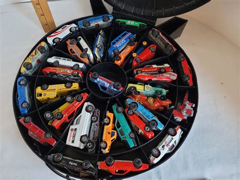 Hot wheels carry case filled with misc. Toy cars.