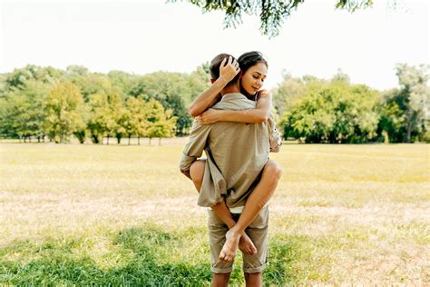 Premium Photo | Horizontal image of a young man carrying his beautiful smiling woman on his back ...