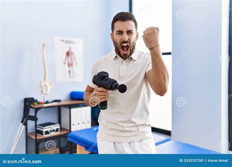 Handsome Hispanic Man Holding Therapy Massage Gun at Physiotherapy ...