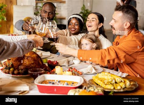 Happy family celebrate Thanksgiving day, sitting at table with roasted ...