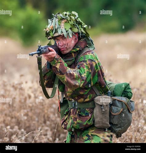 1970 – 1980 British Army soldier in camouflage suit and steel helmet ...