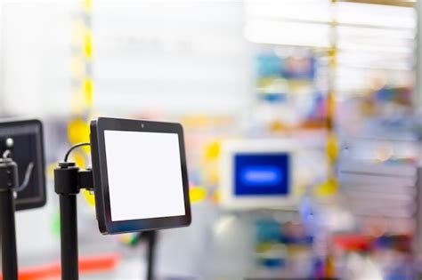 Monitor white screen mockup hanging in a supermarket at the checkout ...