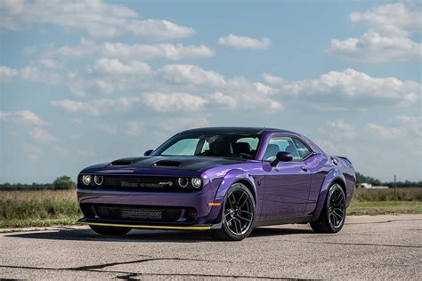 Download A Purple Dodge Challenger Srt Parked On A Road Wallpaper | Wallpapers.com