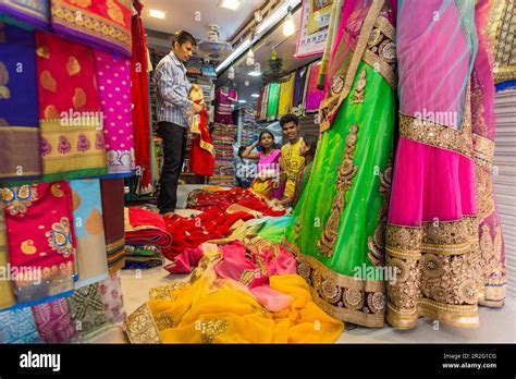 Textile shop with colourful fabrics for sari, street scene Bhuleshwar ...