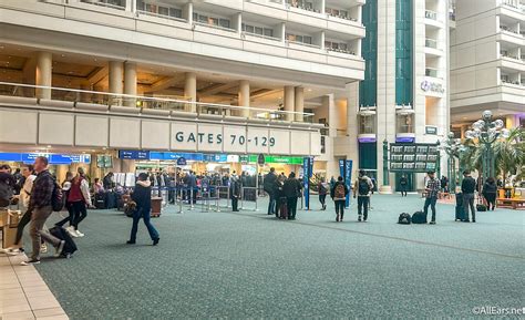 Passengers look at flight delays on a departure board at Orlando International Airport on November 0