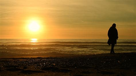 Woman Walking Alone Along the Beach During Scenic Sunset 24480151 Stock ...