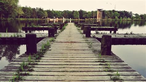 Pier over lake against clear sky | Premium Photo