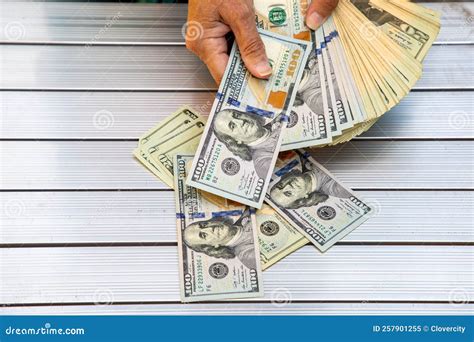 Hand with stack of money stock image. Image of currency - 257901255