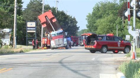Pewaukee dump truck mishap; power lines snagged | FOX6 Milwaukee