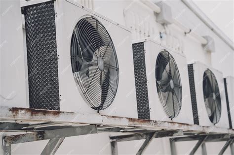 Premium Photo | A row of split air conditioner condensers on a wall of ...
