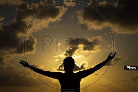 Image of Figure Of A Woman'S Body With Arms Outstretched During Sunrise ...