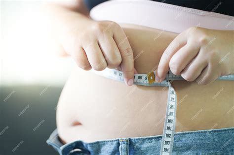 Premium Photo | Mothercare pregnant woman measuring her belly growth of ...