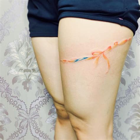 Ribbon Tattoo On Thigh