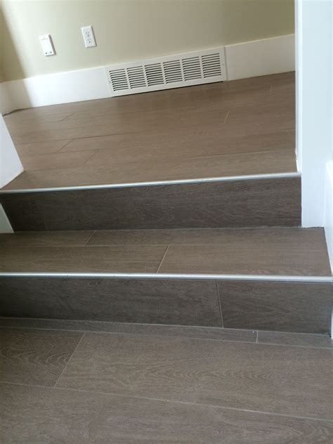 Wood floor tile on stairs with metal end cap Tiled Staircase, Stairs ...