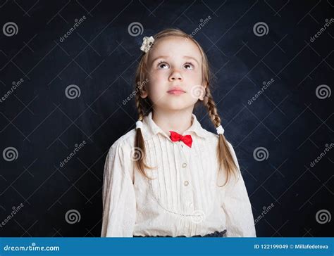 Cute Little Girl Looking Up on Blackboard Stock Image - Image of ...