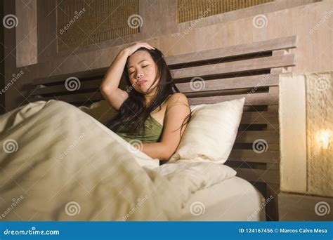 Young Beautiful Depressed and Sad Asian Chinese Woman Having Insomnia Lying in Bed at Night ...