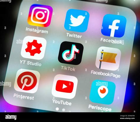 Social media app icons in folder on iPhone screen Stock Photo - Alamy