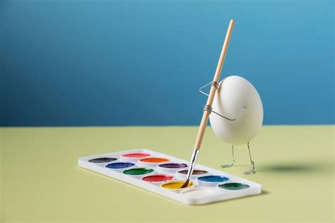 Animated egg holding brush still life | Free Photo