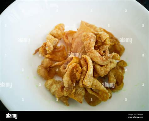 Close up of deep-fried chicken skins in a white bowl Stock Photo - Alamy