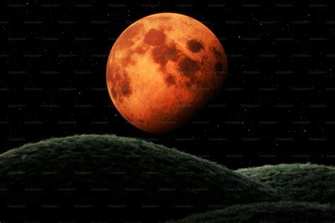 A red moon is seen in the night sky photo – Wallpaper Image on Unsplash