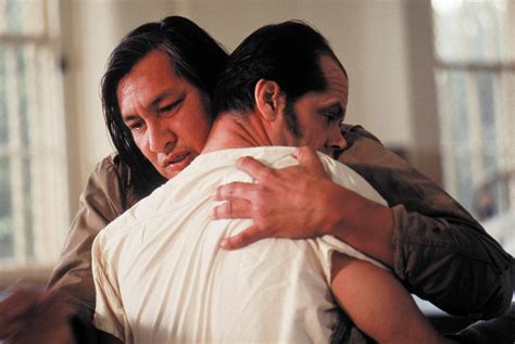 Download Will Sampson Movie Scene Hugging A Man Wallpaper | Wallpapers.com