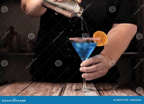 Waiter Serving a Blue Colored Cocktail Stock Photo - Image of liquid ...