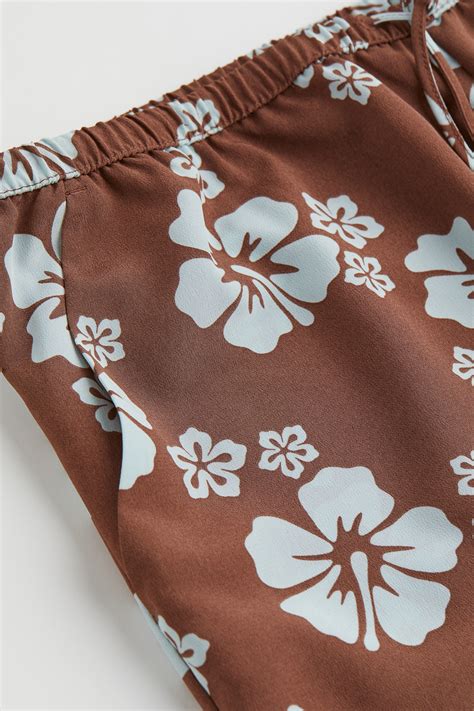 Linen-blend pull-on trousers - Brown/Tropical flowers - Ladies | H&M IN