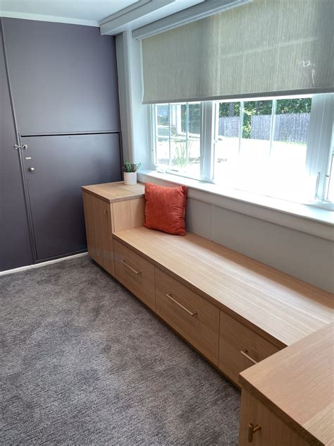 Window Bench Seat With White Wooden Cabinets